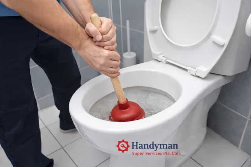 Using plunger to fix toilet choke in Singapore